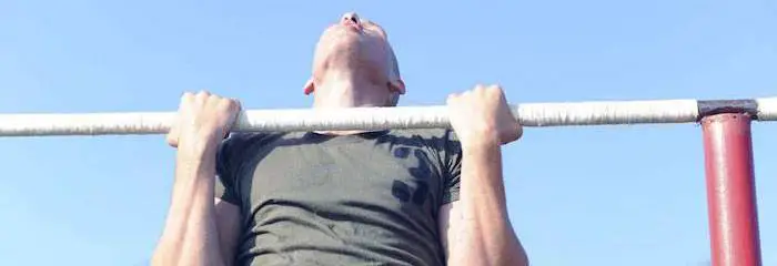 Male marine doing a pullup, which is a core exercise.
