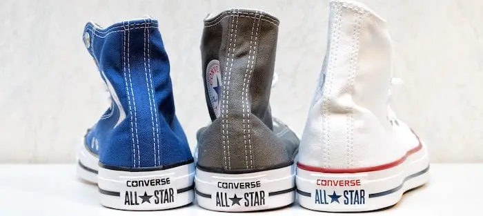 Three pairs of converse, blue, black, and white.