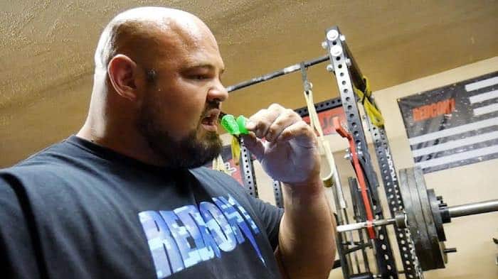 Powerlifter putting in a mouth guard.