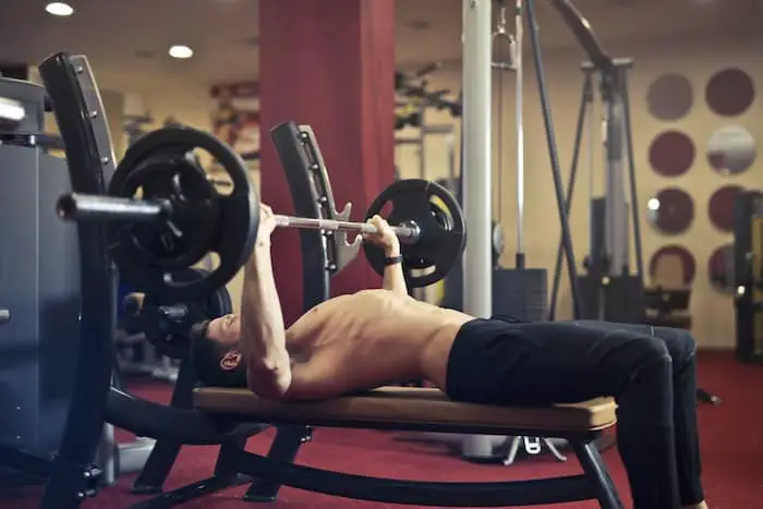 Man bench pressing with an arched lower back.