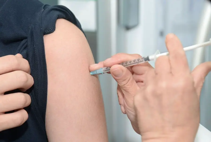 Man injecting steroids into his arm.