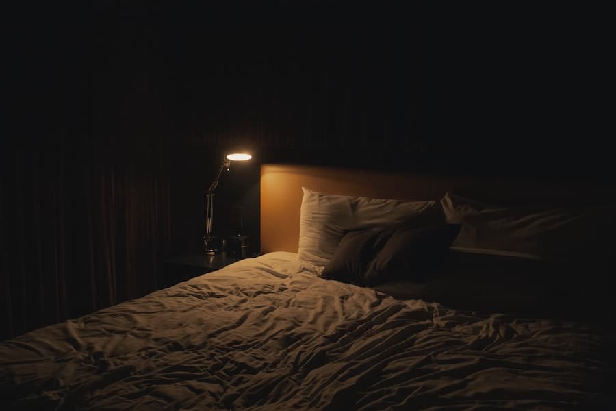 A bed in a dark room.
