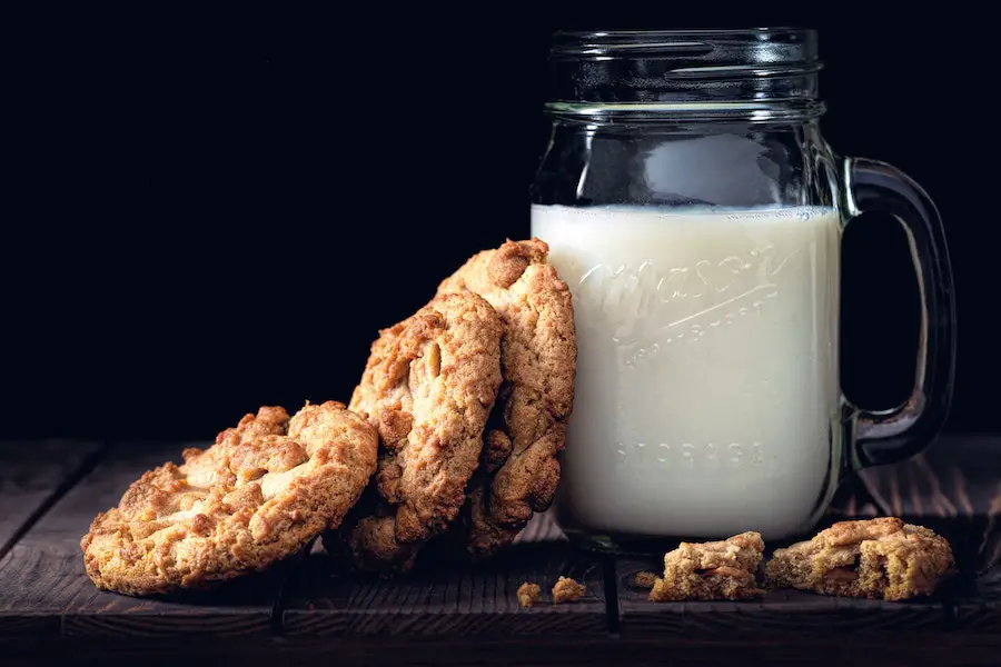 Glass of milk with some cookies.