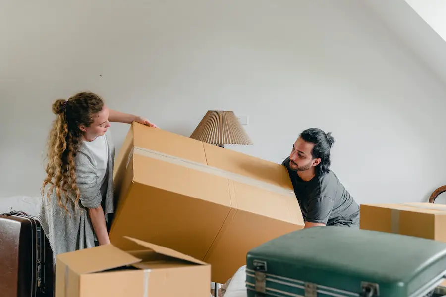 Man and woman moving a box.